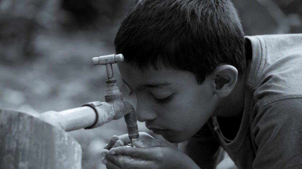 A boy drinking tap water