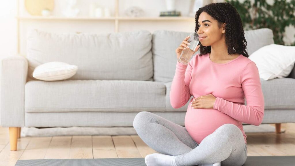 A pregnant woman drinking water 