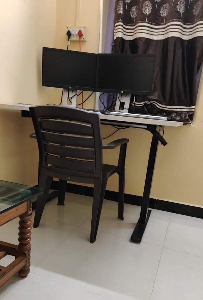 Jin Manual Height Adjustable Desk with a small home office setup